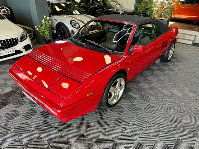 A red Ferrari Mondial photographed in the showroom